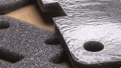 close up of custom cut foam material showing adhesive backing