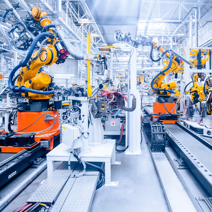 industrial facility with yellow machinery with arms