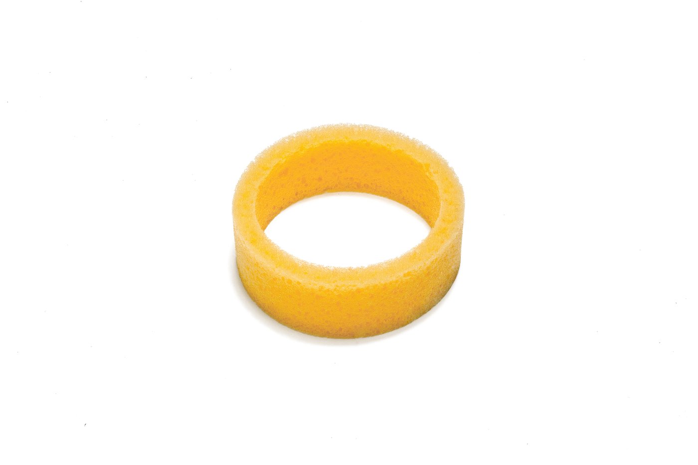 Yellow foam spacer ring on white background