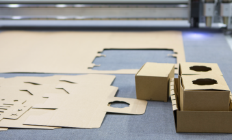 Creasing and scoring packaging material